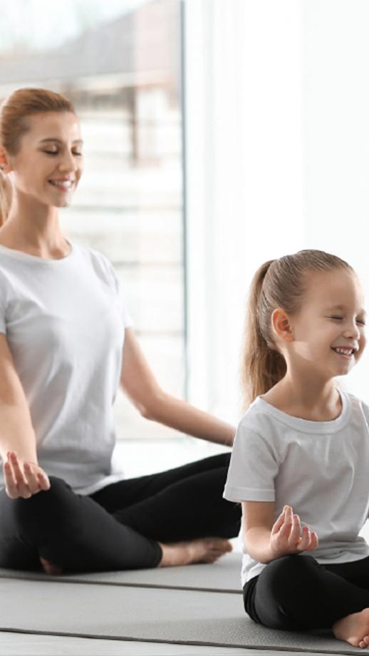 a mother and daughter do yoga poses