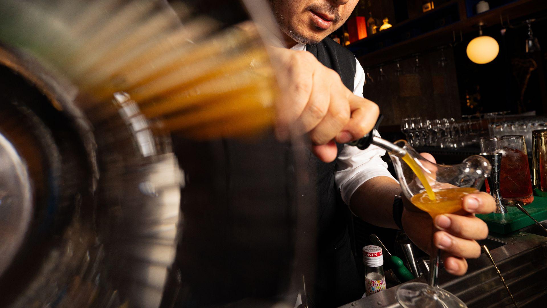 Bartender crafting a cocktail at Demon Duck, the contemporary dining and bar experience at Banyan Tree Dubai.