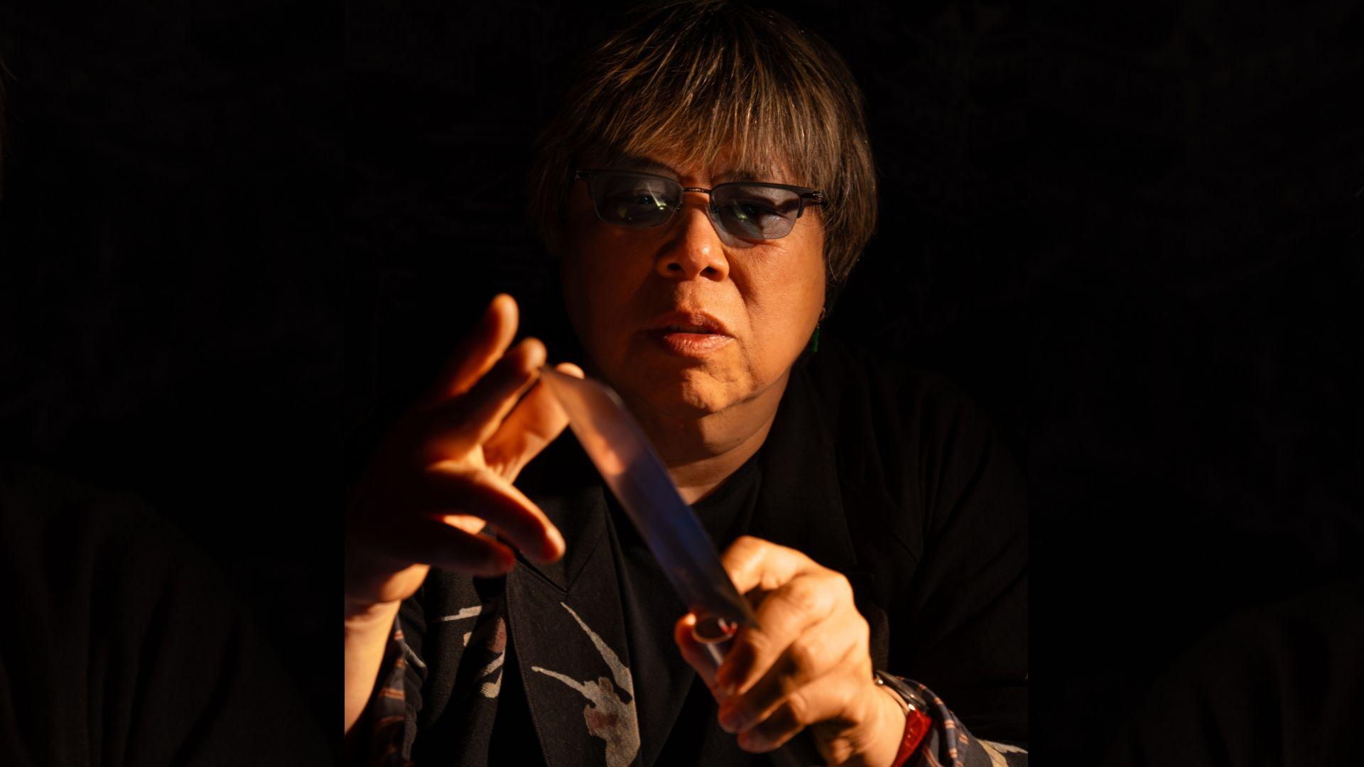 Chef Alvin Leung in a dramatic portrait, holding a knife, showcasing his bold culinary persona at Demon Duck, Banyan Tree Dubai.