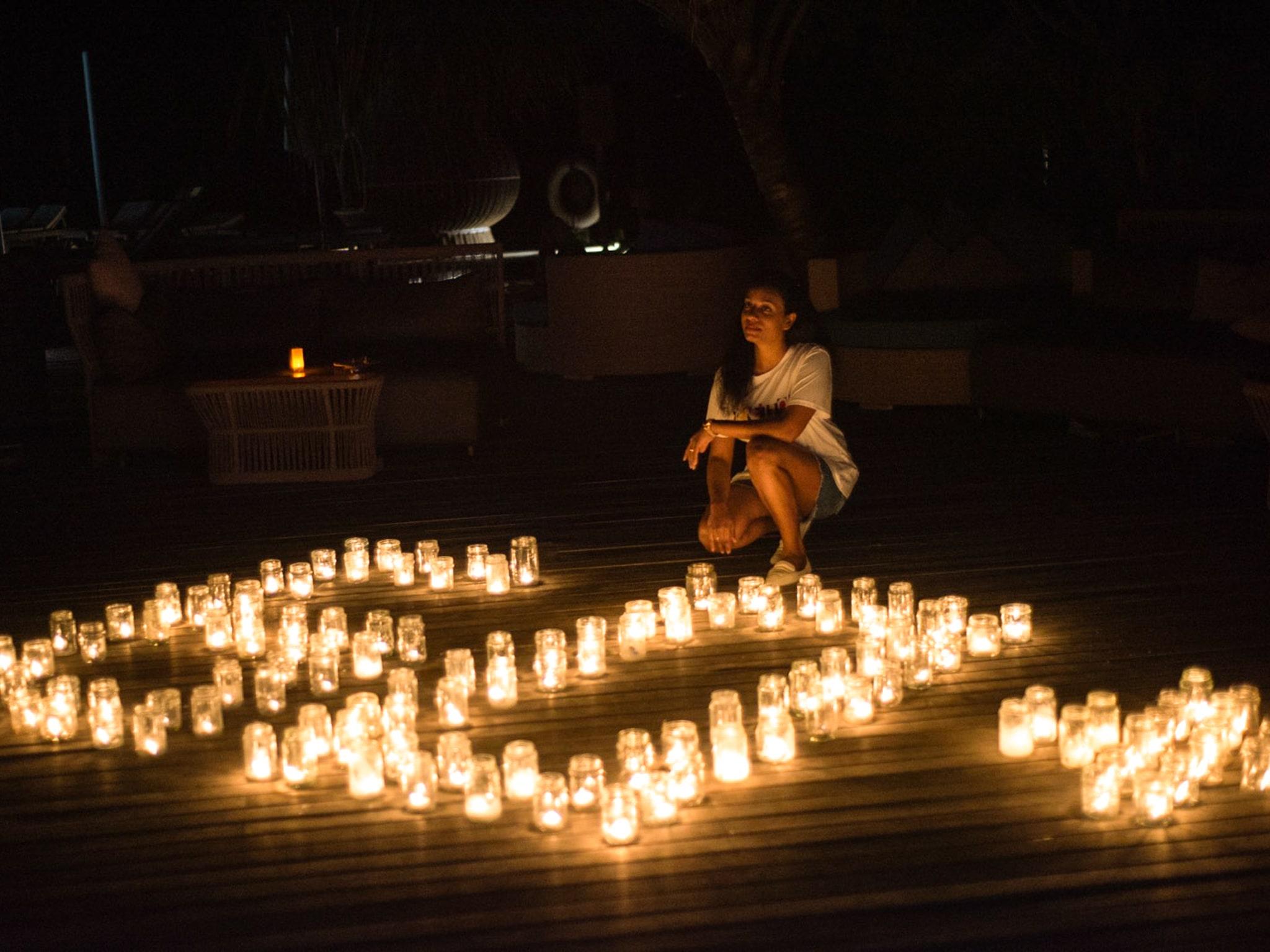 woman in front of candles for Earth Hour