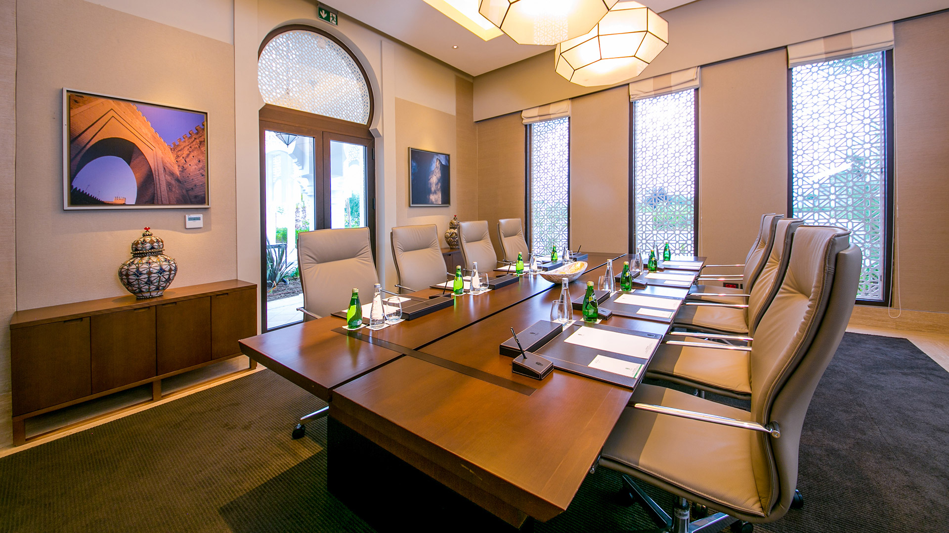 Conference table set with chairs, notepads, and water bottles at Banyan Tree Tamouda Bay.