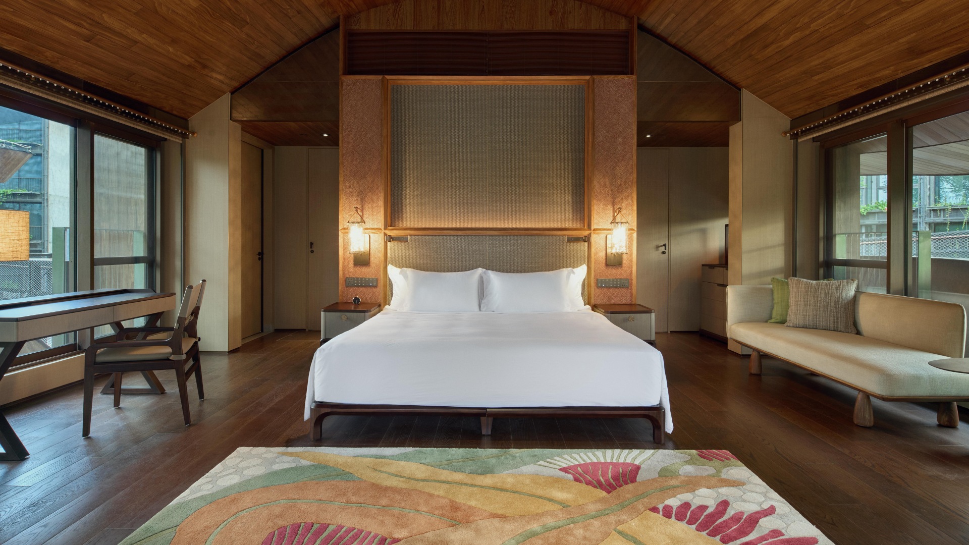 Luxurious treehouse at Mandai Rainforest Resort by Banyan Tree with elegant decor, a private patio and sweeping views.
