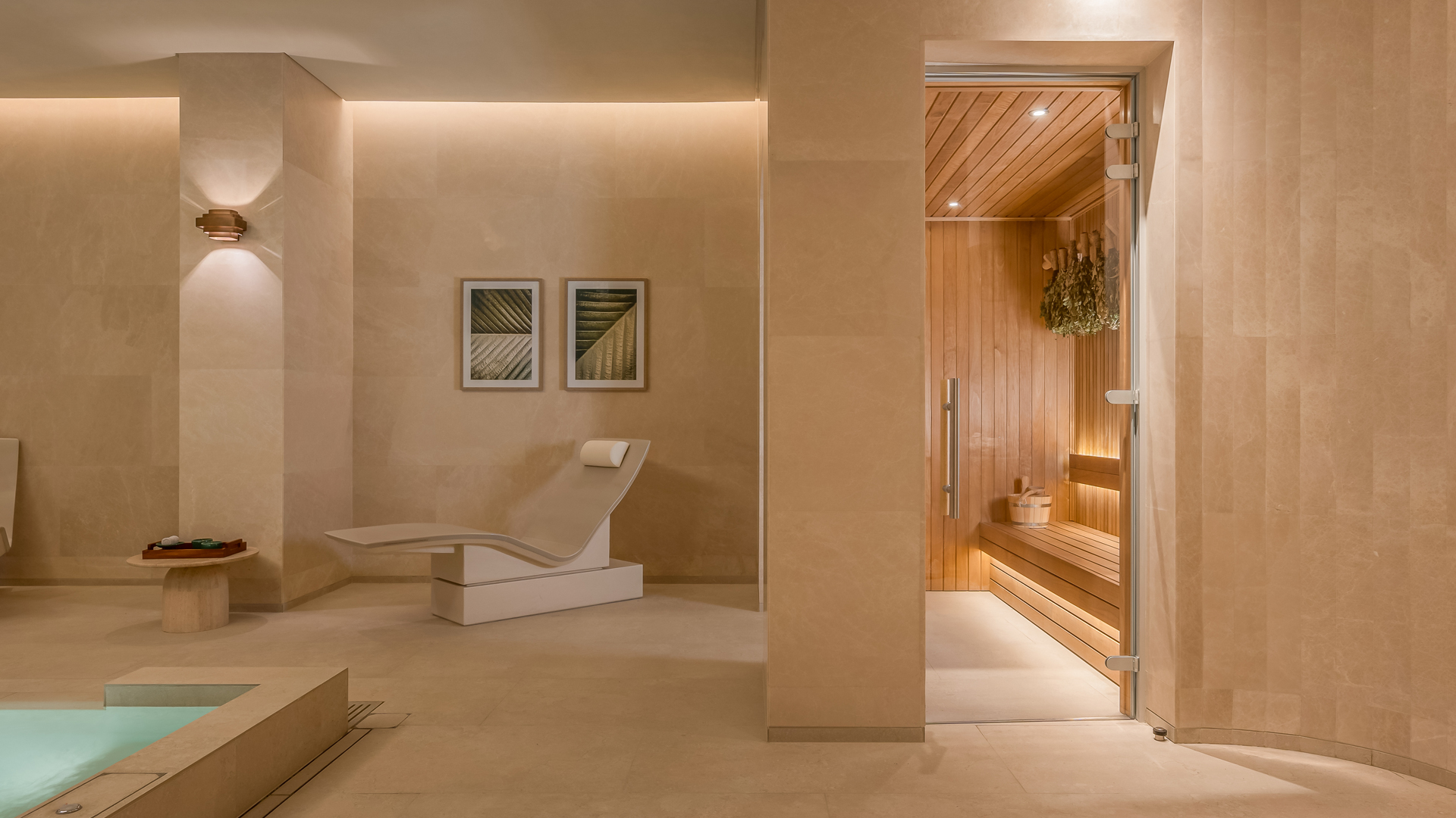 Luxurious spa retreat at Banyan Tree Dubai featuring a serene sauna room and relaxation loungers, complemented by warm lighting and elegant minimalist design.