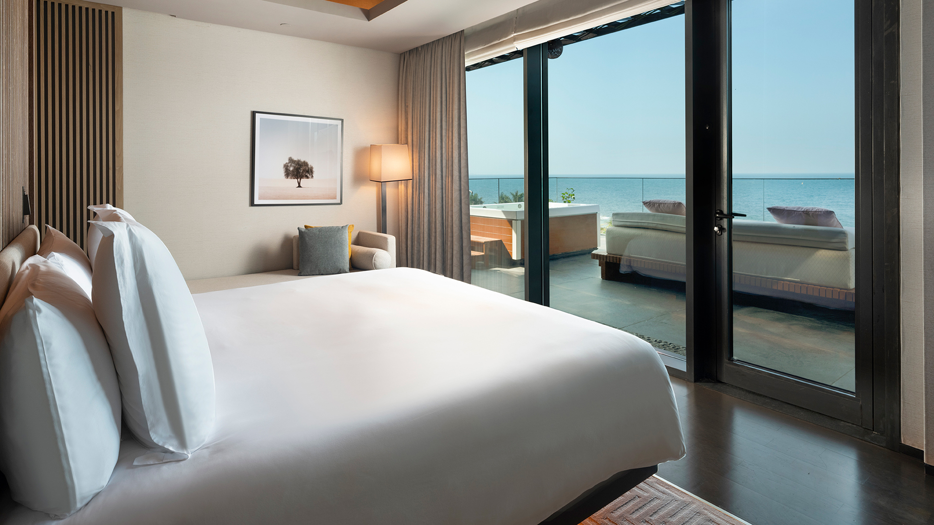 Spacious oceanfront master bedroom at Banyan Tree Dubai featuring modern interiors, private terrace, and uninterrupted views of the Arabian Gulf—ideal for luxurious beachfront stays.