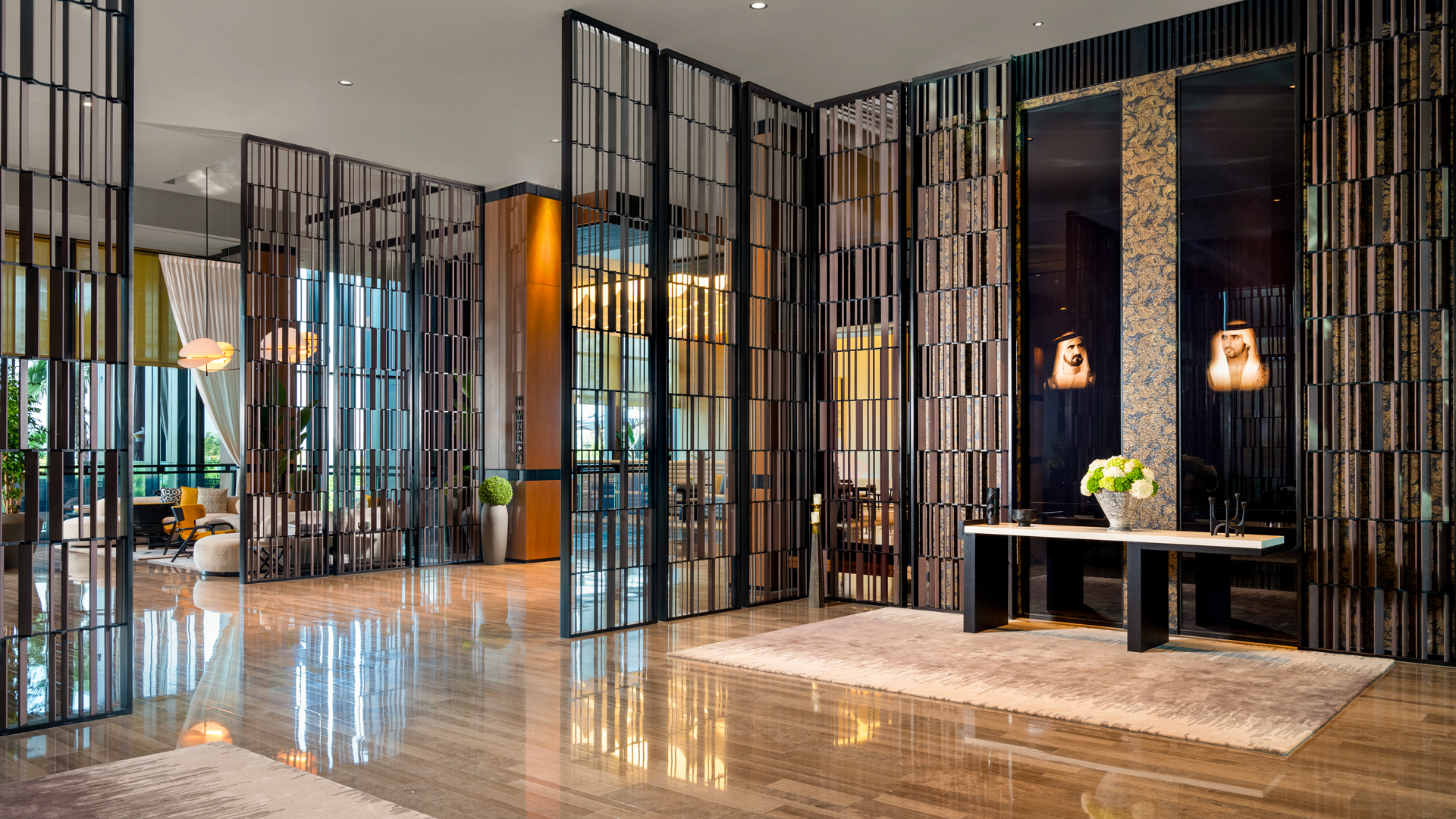 Luxurious lobby entrance at Banyan Tree Dubai featuring elegant wooden screens, marble flooring, and portraits of UAE leaders, reflecting refined Arabian hospitality and modern design.
