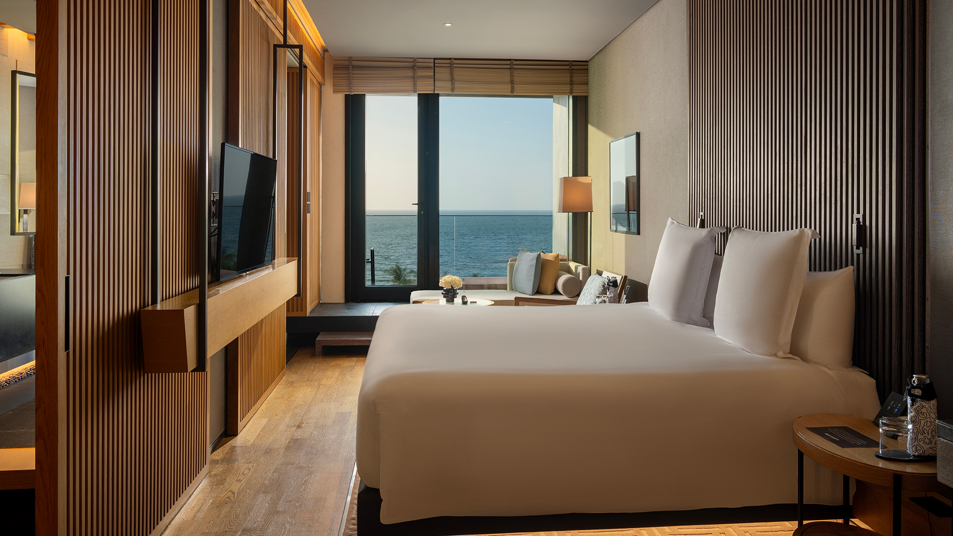 Serenity Oceanview Guestroom King at Banyan Tree Dubai, featuring sleek wooden interiors, plush bedding, and private balcony with panoramic sea views.