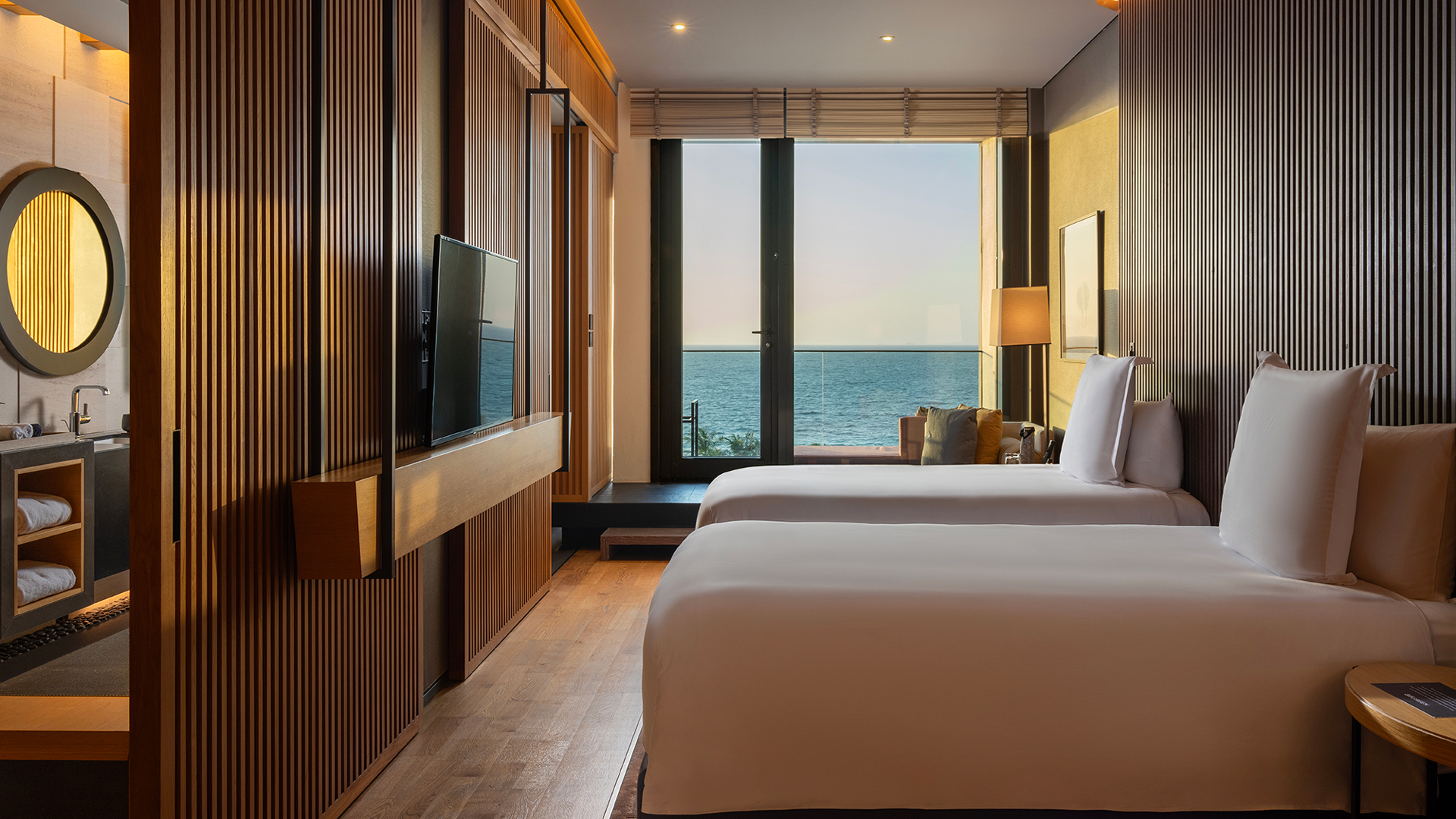 Serenity Oceanview Guestroom with twin beds at Banyan Tree Dubai, offering contemporary wooden interiors, a spacious layout, and balcony views over the Arabian Gulf.