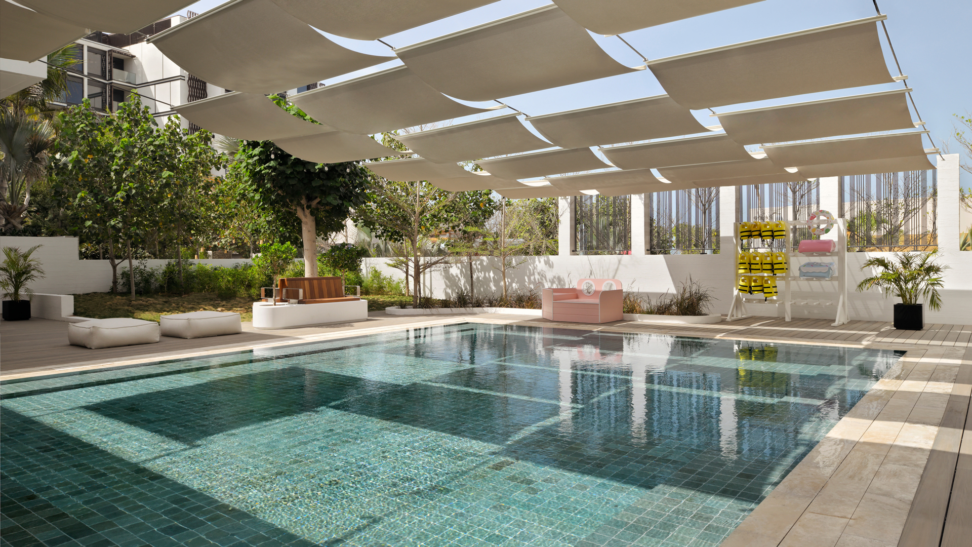 Private villa pool at Banyan Tree Dubai featuring shaded canopy design, contemporary sun loungers, and lush landscaped surroundings for secluded luxury relaxation.