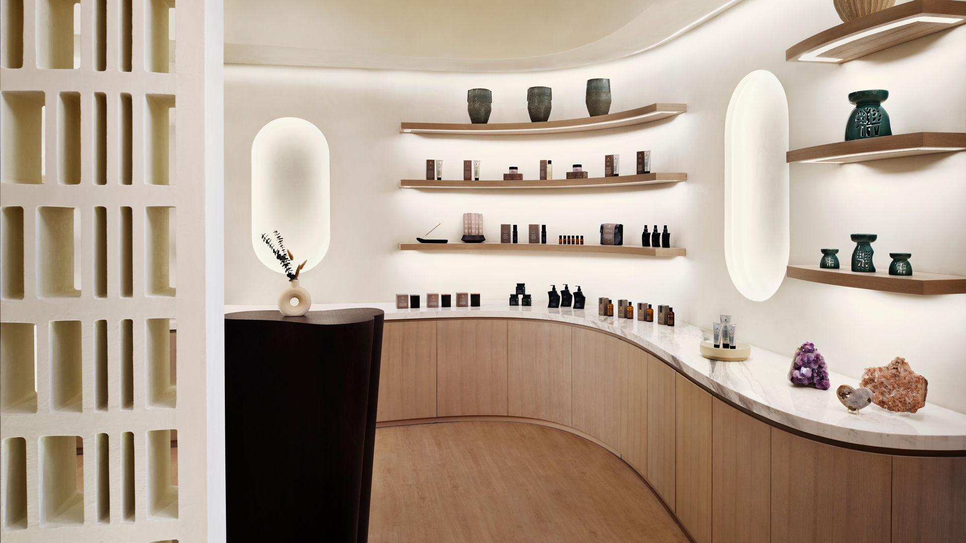 Elegant spa retail area at Banyan Tree Dubai featuring curated wellness products, minimalist wooden shelving, and ambient lighting for a serene shopping experience.