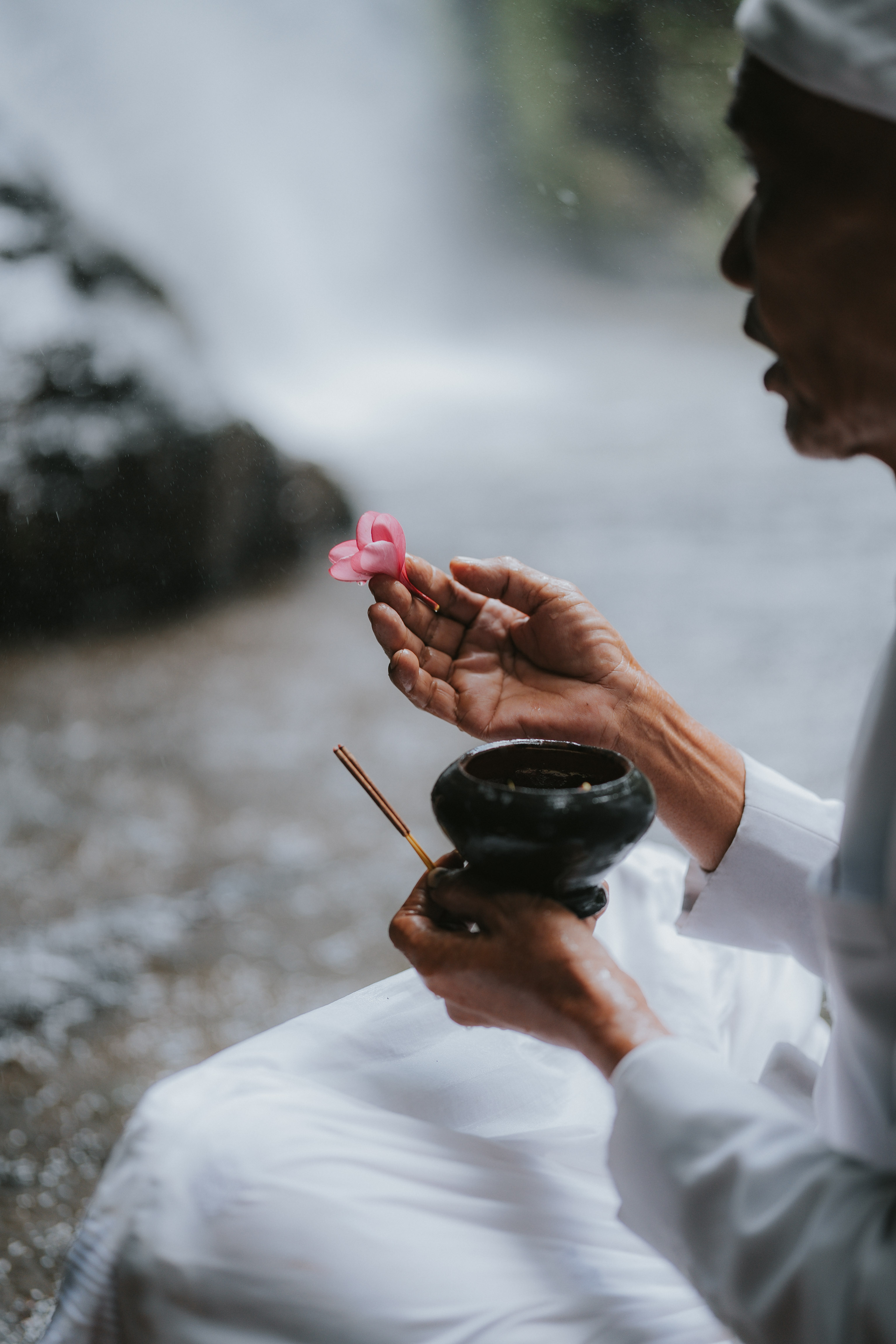 Priest praying in Buahan waterfall